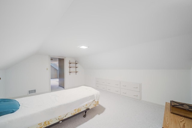 carpeted bedroom featuring vaulted ceiling