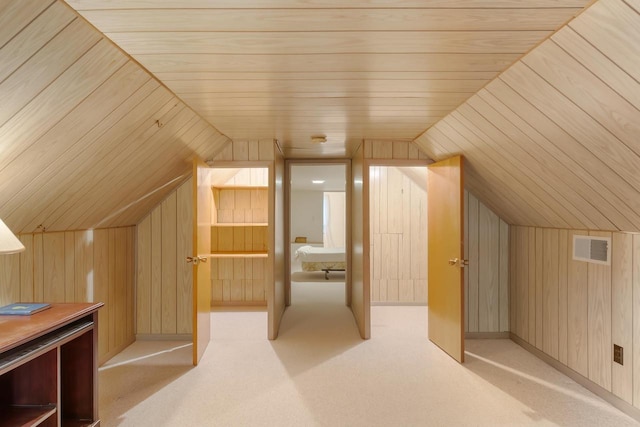 additional living space with wood walls, wooden ceiling, light carpet, and vaulted ceiling