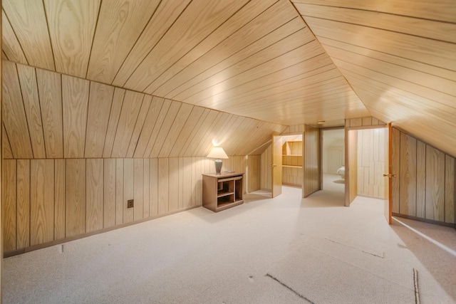 additional living space with wooden ceiling, wooden walls, and light carpet