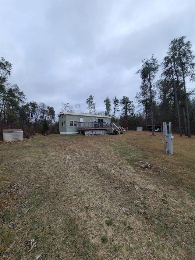 view of yard with a deck and a shed