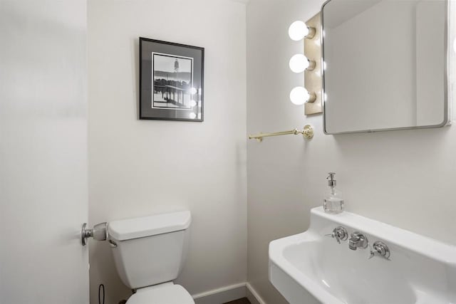 bathroom featuring toilet and sink