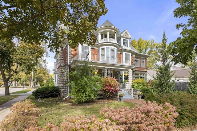 victorian house with a porch and a balcony