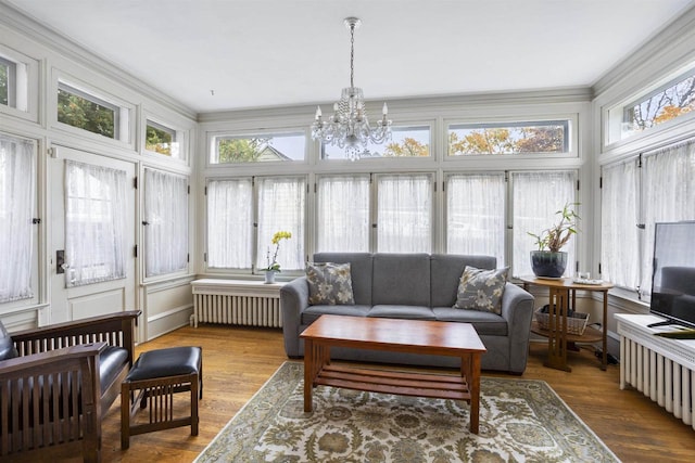 sunroom with a chandelier and radiator