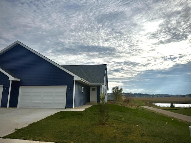 view of home's exterior featuring a lawn and a garage