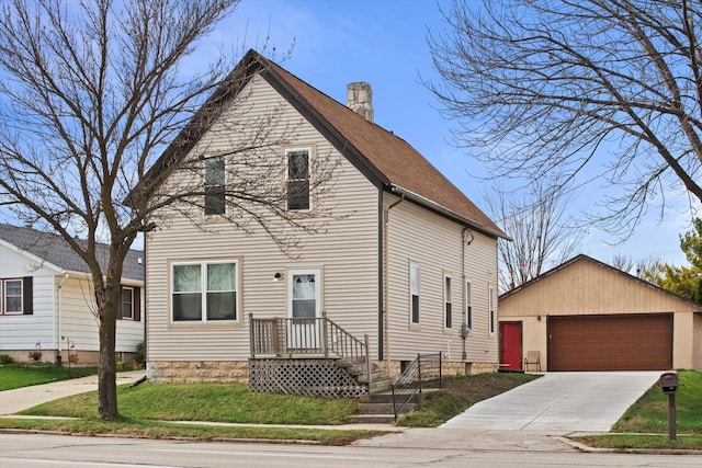 view of front of property with a front lawn, a garage, and an outdoor structure