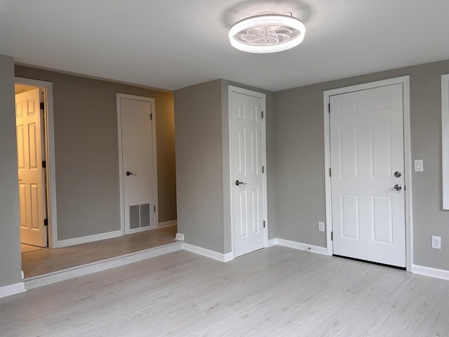 unfurnished bedroom with light wood-type flooring