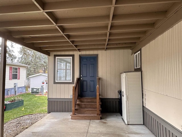 view of exterior entry with a lawn