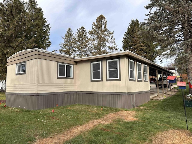 view of side of home featuring a lawn and a patio