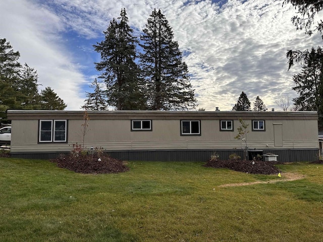 rear view of property with a yard