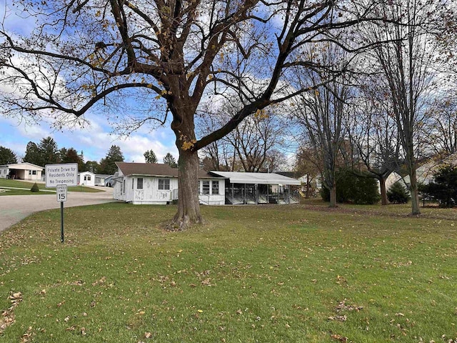 single story home with a front yard and a carport