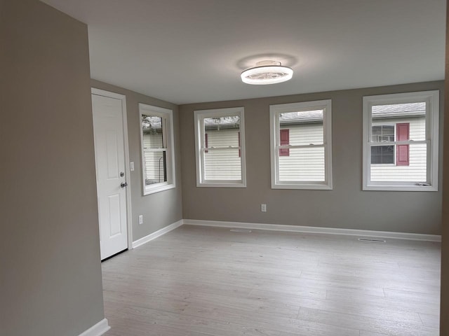 empty room featuring light hardwood / wood-style floors and a healthy amount of sunlight