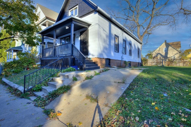 view of front of home featuring a front yard and a porch