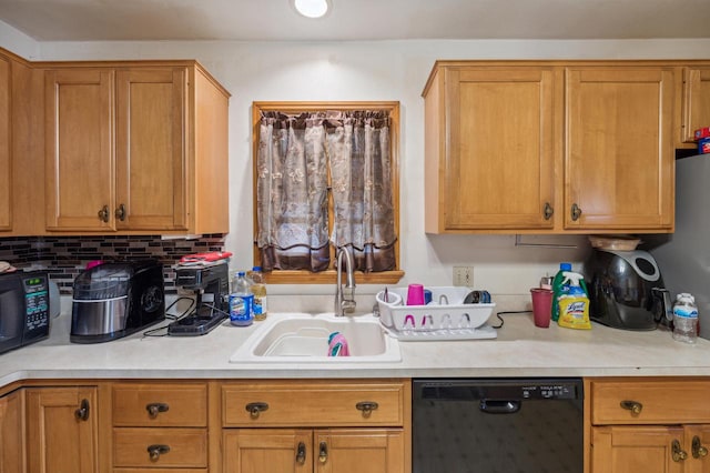 kitchen featuring sink, black appliances, and tasteful backsplash