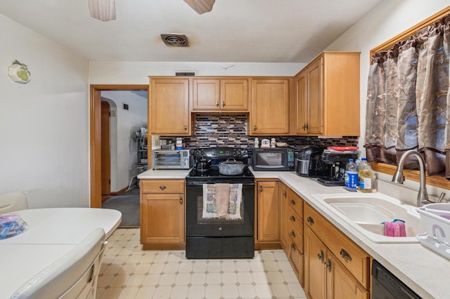 kitchen featuring ceiling fan, sink, black appliances, and tasteful backsplash