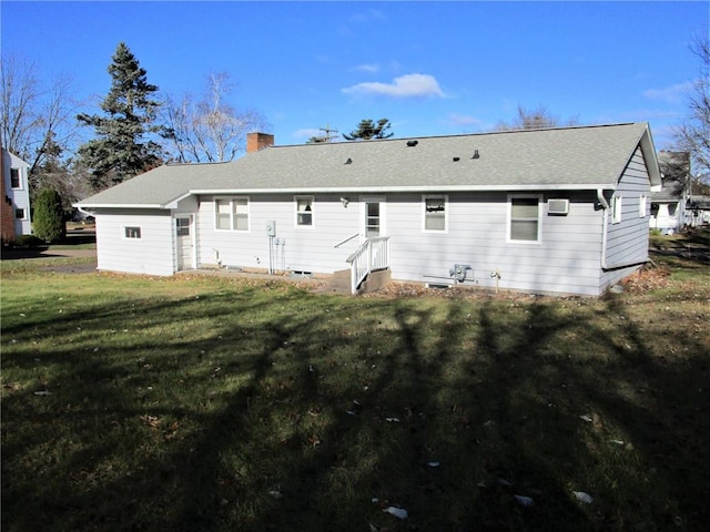 rear view of property with a lawn