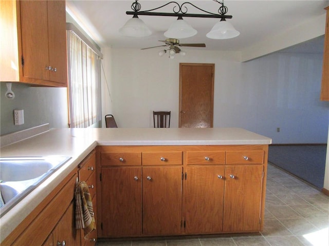 kitchen featuring kitchen peninsula, hanging light fixtures, ceiling fan, and light tile patterned flooring