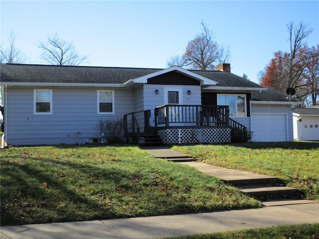 ranch-style home with a garage and a front lawn