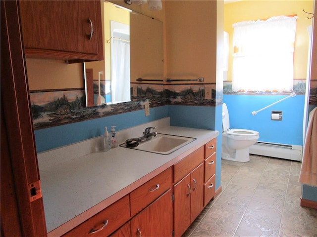 bathroom featuring vanity, toilet, and a baseboard heating unit