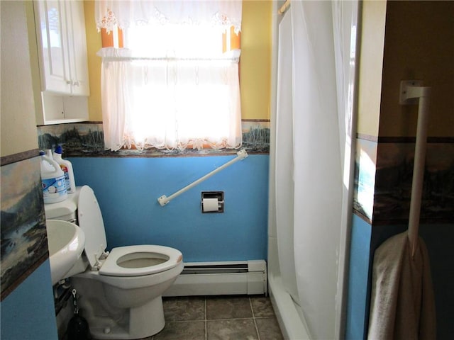 bathroom featuring toilet, tile patterned flooring, and a baseboard radiator