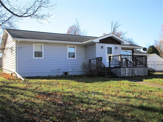 rear view of house featuring a deck and a lawn