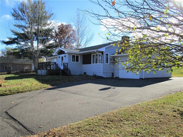 view of property exterior with a garage and a yard