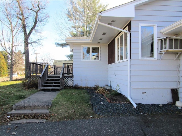 view of side of home featuring a wooden deck