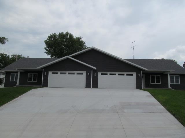 ranch-style home featuring a garage and a front yard