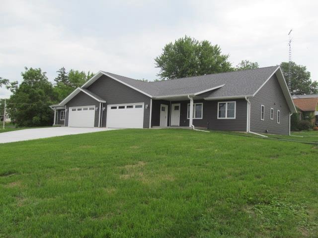 ranch-style house featuring a garage and a front yard