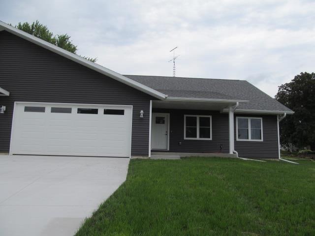 ranch-style house with a garage and a front yard