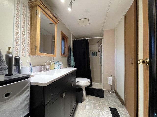 219 N 8th Ave W, Washburn, WI 54891 - full bath featuring toilet, vanity, a stall shower, and stone finish floors