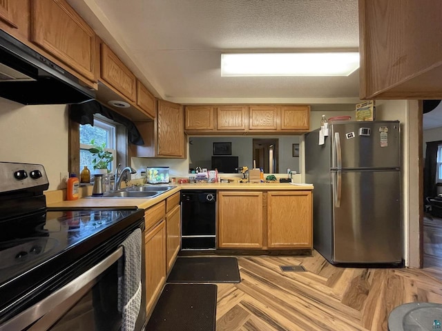 kitchen featuring light parquet floors, appliances with stainless steel finishes, a textured ceiling, exhaust hood, and sink