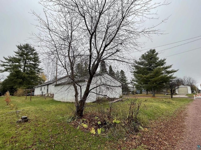 219 N 8th Ave W, Washburn, WI 54891 - view of side of property featuring a yard and an outbuilding