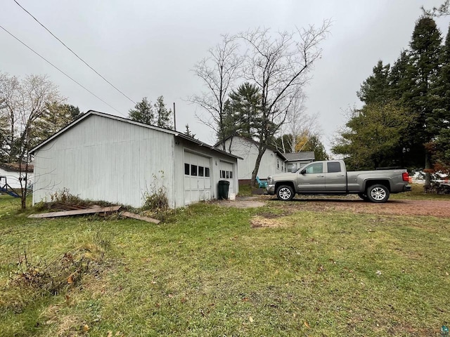 219 N 8th Ave W, Washburn, WI 54891 - view of home's exterior featuring a garage and a lawn