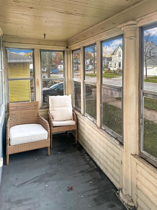 unfurnished sunroom featuring wooden ceiling and a wealth of natural light