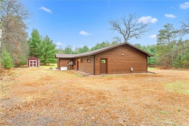 view of side of property featuring a shed