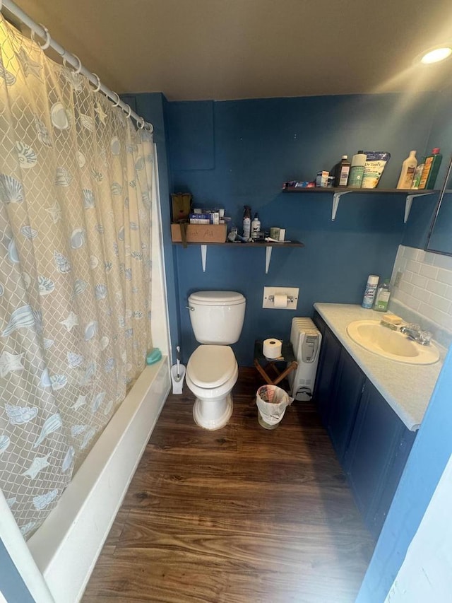 full bathroom with shower / bath combo, toilet, vanity, and hardwood / wood-style flooring