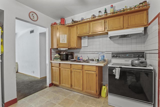 kitchen with white range with electric stovetop, backsplash, sink, and light colored carpet