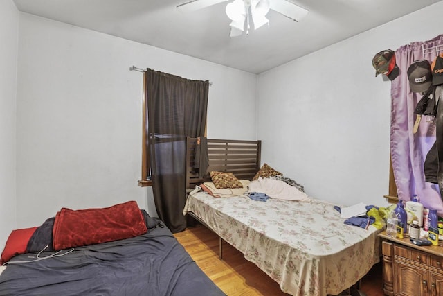 bedroom with light hardwood / wood-style flooring and ceiling fan