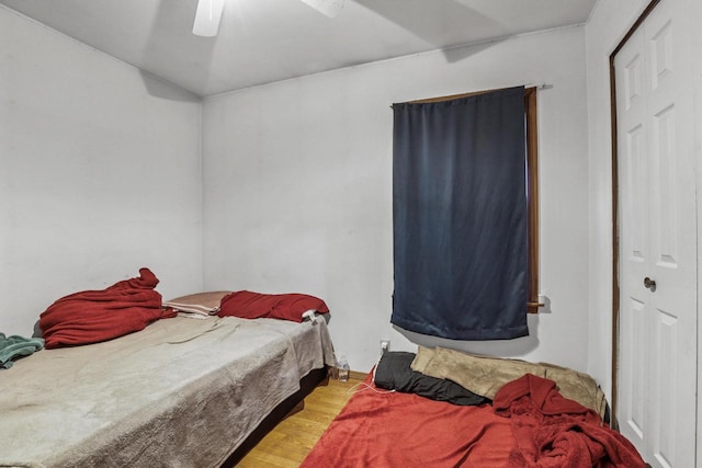 bedroom featuring hardwood / wood-style floors, ceiling fan, and a closet