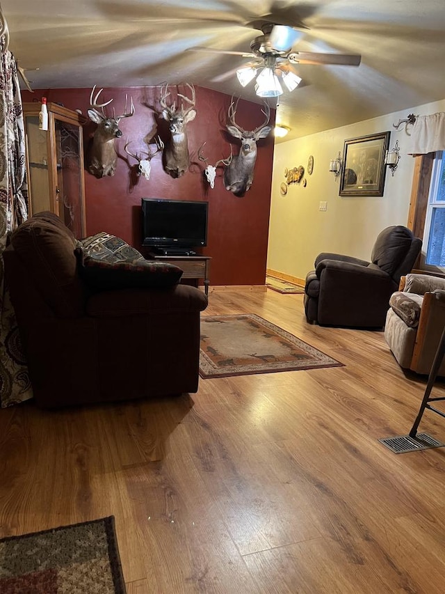 living room featuring ceiling fan and wood-type flooring