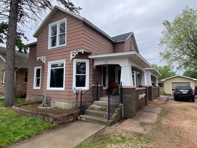 view of front of home with a garage and an outdoor structure