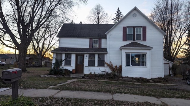 view of front property with a garage and an outdoor structure