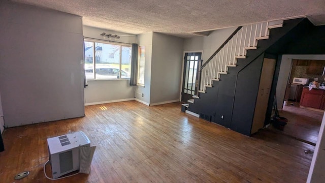 foyer entrance featuring wood-type flooring and a textured ceiling