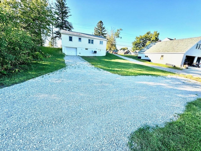 view of front of property with a garage and a front lawn