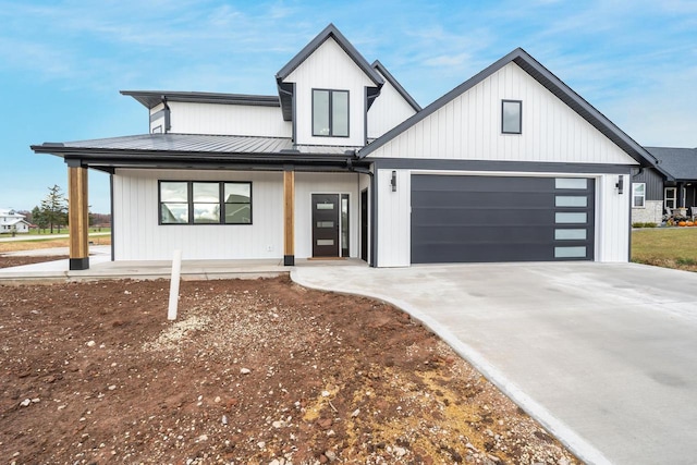 modern inspired farmhouse with a garage and a porch