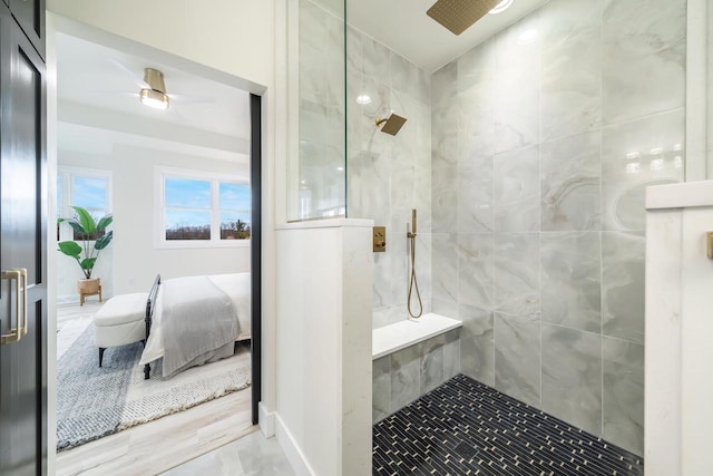 bathroom with ceiling fan, hardwood / wood-style floors, and a tile shower