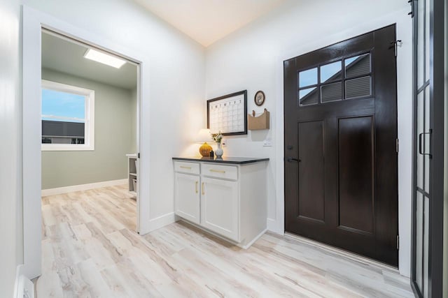 foyer entrance with light hardwood / wood-style floors