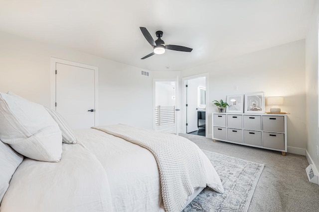 bedroom featuring carpet floors, ceiling fan, and ensuite bathroom