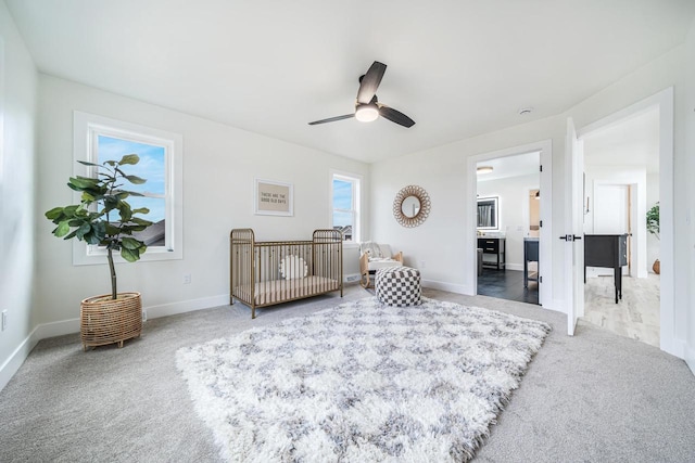 carpeted bedroom featuring multiple windows and ceiling fan