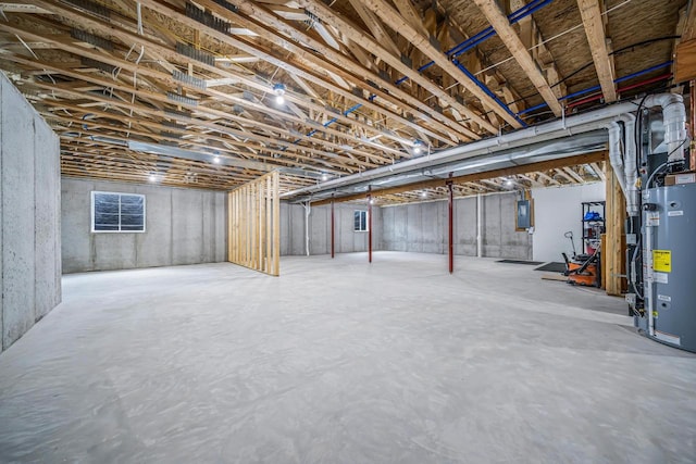 basement featuring electric panel and gas water heater